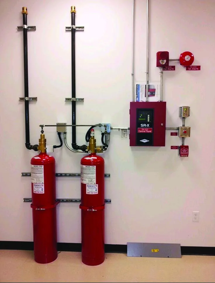 Twin fire suppression cylinders and control panel commissioned in a commercial kitchen